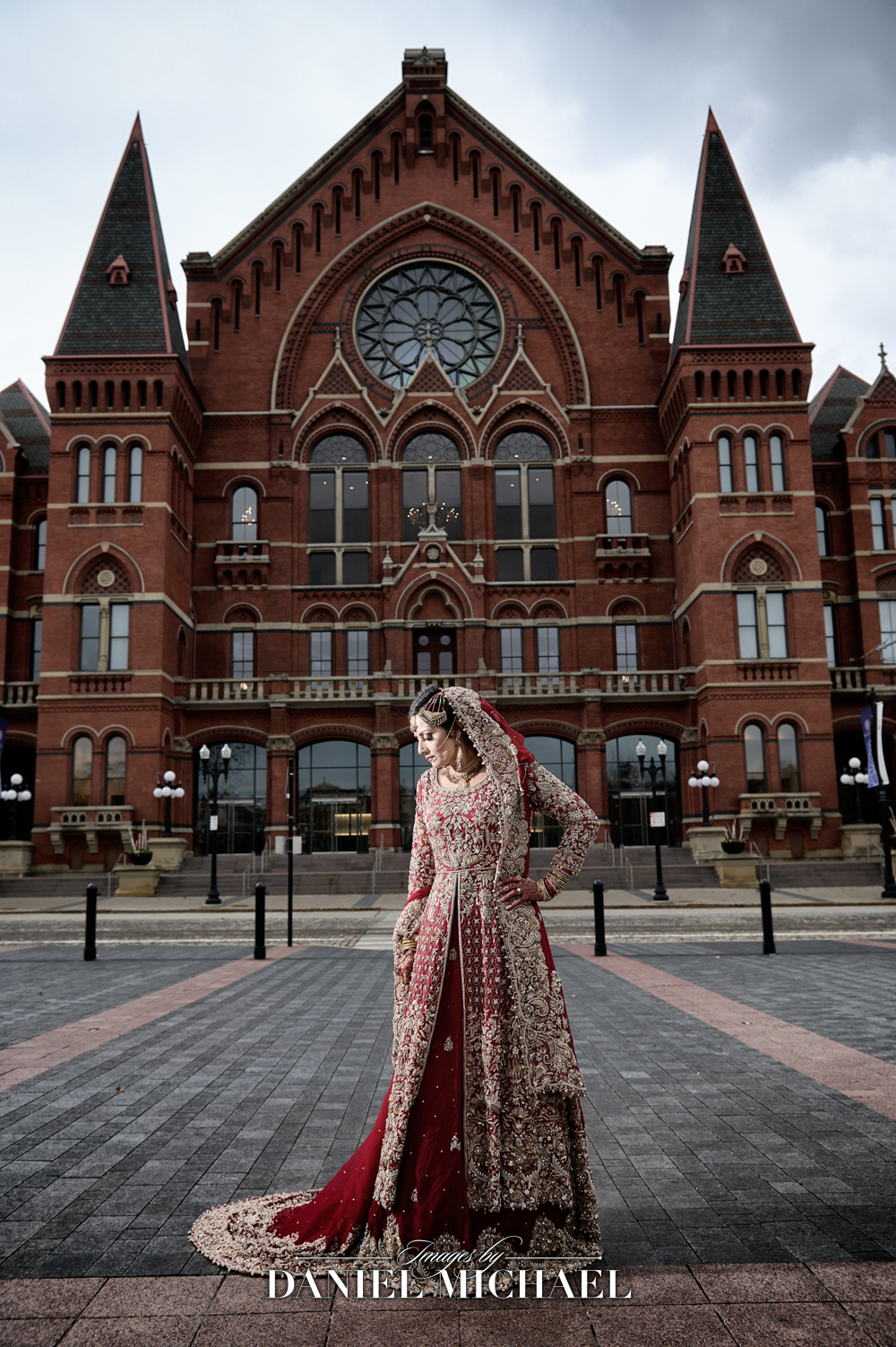 Muslim bride in red and gold lehenga with intricate embroidery, photographed at Cincinnati Music Hall